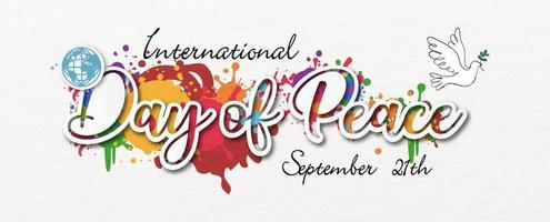 The day of peace wording in paper cut out style with dove peace and global on colorful pattern and white paper pattern background. Poster's campaign in banner and vector design.