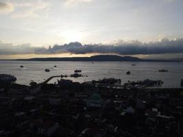 Sunset aerial view of Port in Banyuwangi Indonesia with ferry in Bali Ocean photo