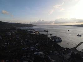 Sunset aerial view of Port in Banyuwangi Indonesia with ferry in Bali Ocean photo