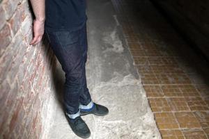 The man in the authentic boots and selvedge jeans  on a background of old city photo