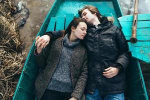 man and woman lie in the boat photo