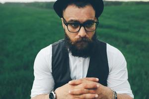 man with a beard, thinking in the field photo