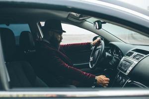 Man with beard driving a car photo