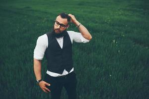 man with a beard, thinking in the field photo