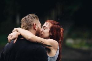 beautiful couple hugging in the rain photo