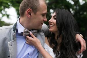 Young European couple cuddling on a park bench photo