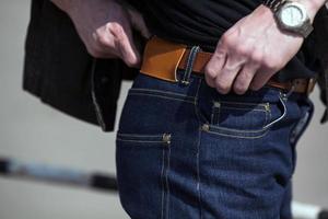 A man dressed in jeans, a close-up shot photo