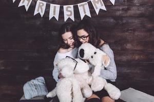 Two charming girls playing with Christmas toys photo