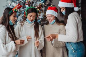 Multi-ethnic young people celebrating New year eve holding sparklers photo