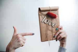 The girl holds in hands charming gift for her loved one photo