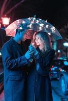 Portrait of a guy and a girl under an umbrella photo