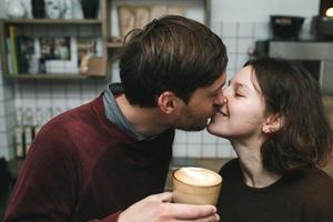 Vintage couple preparing coffee with vacuum coffee maker.Coffee shop photo