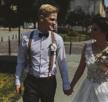 bride and groom walking around the city photo