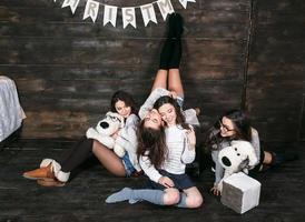 Four charming model posing on a vintage New Year's background photo