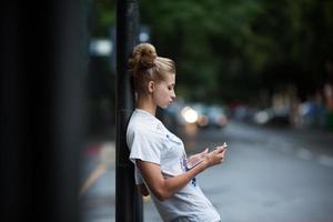 Cute girls with tablet on a bus station photo