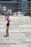 Budapest, Hungary, 2014. Ballerina posing on the steps of the Hungarian Parlaiament building photo