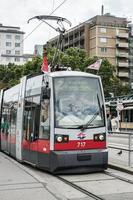 Vienna, Austria, 2014. Red and grey Tram at a station in Vienna photo