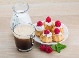 Profiterole with raspberry photo