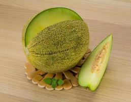 Melon on wooden board and wooden background photo