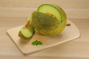 Melon on wooden board and wooden background photo