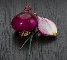 Red onion on wooden background photo