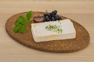 Brie cheese on wooden board and wooden background photo