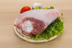 Turkey leg on wooden board and wooden background photo