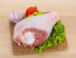 Turkey leg on wooden board and wooden background photo