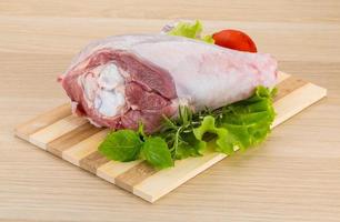 Turkey leg on wooden board and wooden background photo