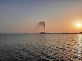 Beautiful sunset at Jeddah, Corniche. The Jeddah Corniche, also known as the Jeddah Waterfront, is a coastal area of the city of Jeddah, Saudi Arabia. Located along the Red Sea. photo