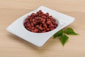 Red beans in a bowl on wooden background photo