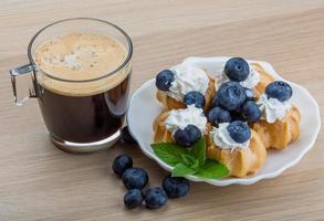 Profiterole with blueberry photo