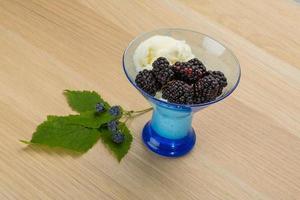 Ice cream with blackberry on wooden background photo