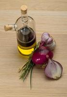 Oil, vinegar with onion on wooden background photo