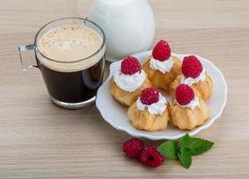 Profiterole with raspberry photo