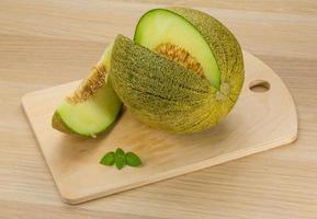 Melon on wooden board and wooden background photo