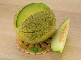 Melon on wooden board and wooden background photo