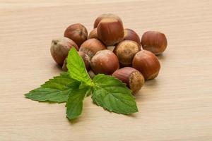 Hazelnut heap on wooden background photo