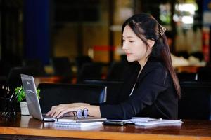 The concept of a business woman using a computer to check financial statements and investments via the Internet. photo