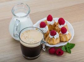 Profiterole with raspberry photo