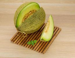 Melon on wooden board and wooden background photo