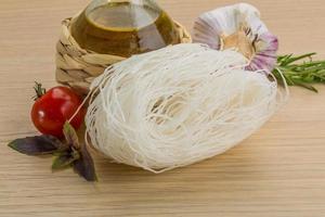 Rice noodle on wooden background photo