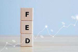 FED, federal reserve, Control interest rates, Inflation, Interest rates. World economy crisis, American economy and business concept. FED word on Wooden block and line chart with Percentage sign. photo