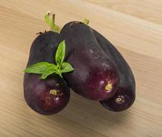 Eggplant on wooden background photo