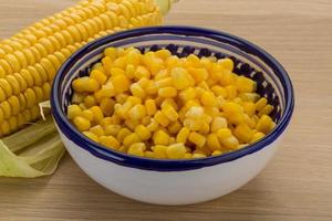 Sweet corn in a bowl on wooden background photo