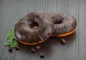 Chocolate donuts on wooden background photo