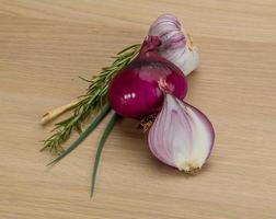 Red onion on wooden background photo