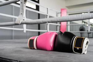 pink and black Boxing glove in punching in woman concept. photo