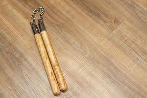 Nunchuks. Wood nunchuks with metal chain. Wooden nunchaku. photo