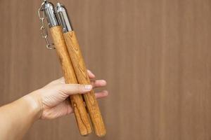 Nunchuks. Wood nunchuks with metal chain. Wooden nunchaku. photo